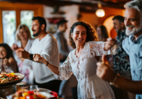 A diverse group of people from Spain, enjoying a vibrant gathering with food and dancing outdoors.